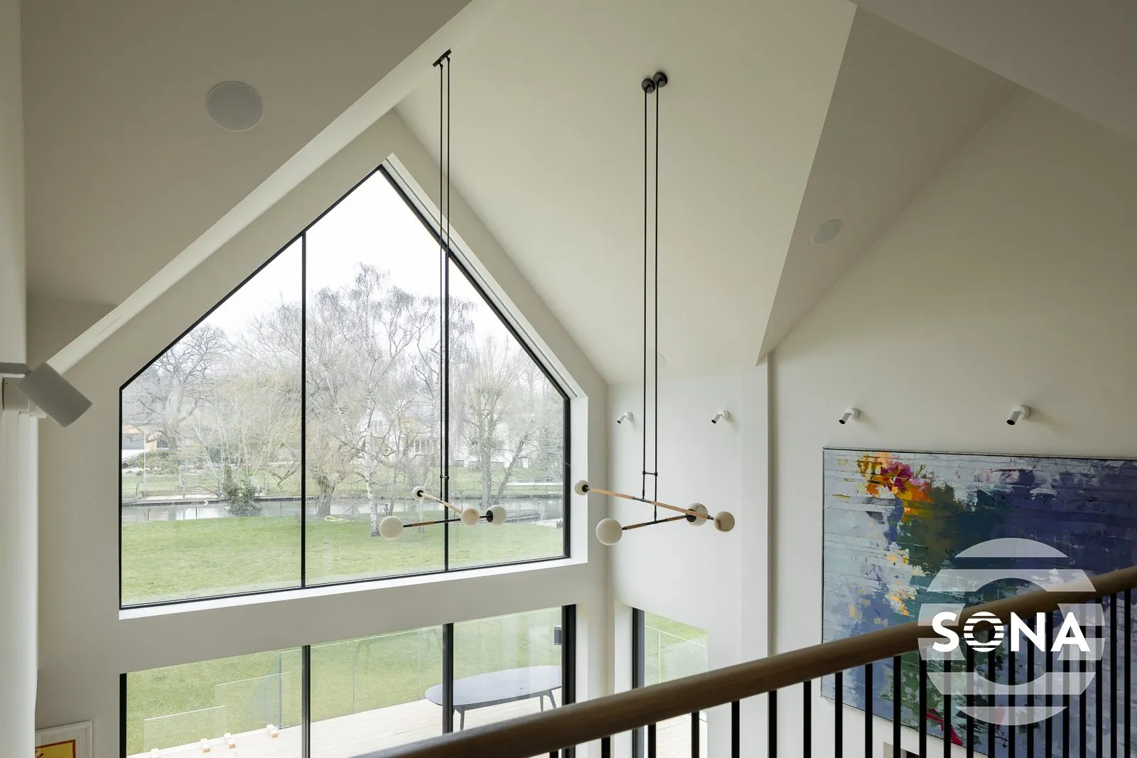floor to ceiling angled shaped window fitted with a gable window blind viewed from the upper level.