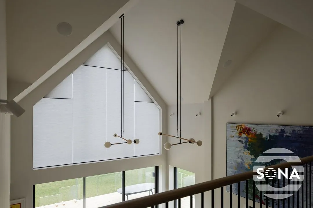 bespoke white electric gable end blinds closing over a large gable window