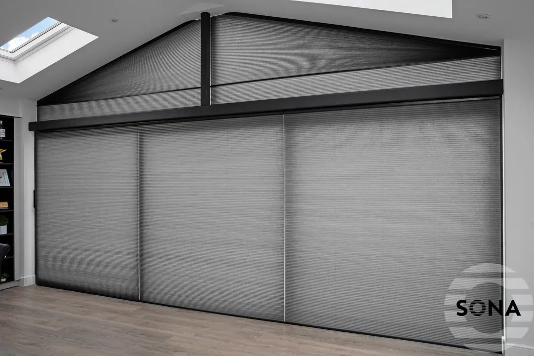 closed grey coloured gable window blinds in a room with laminate flooring