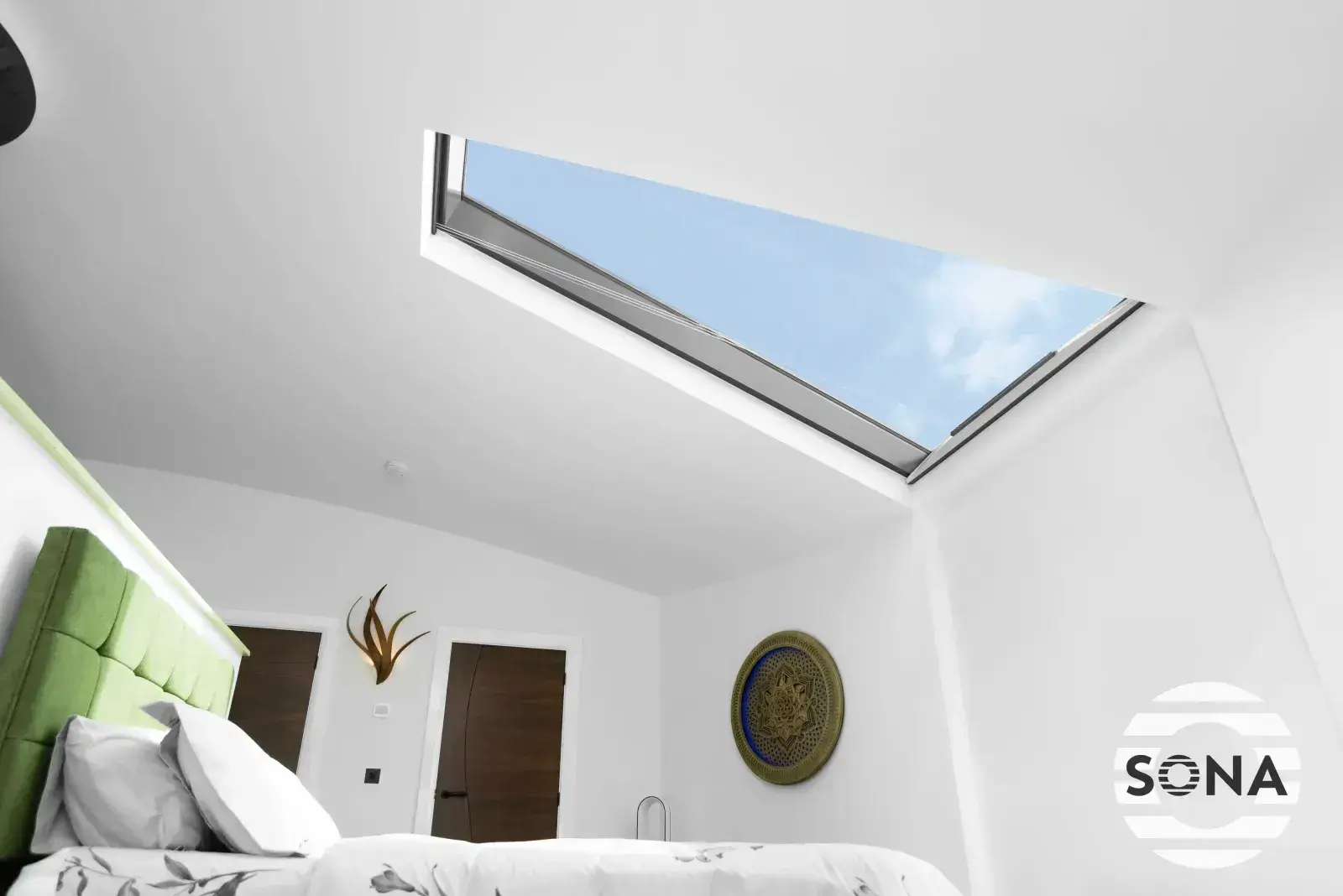 a bedroom setting showing a custom-made rooflight blind fully open