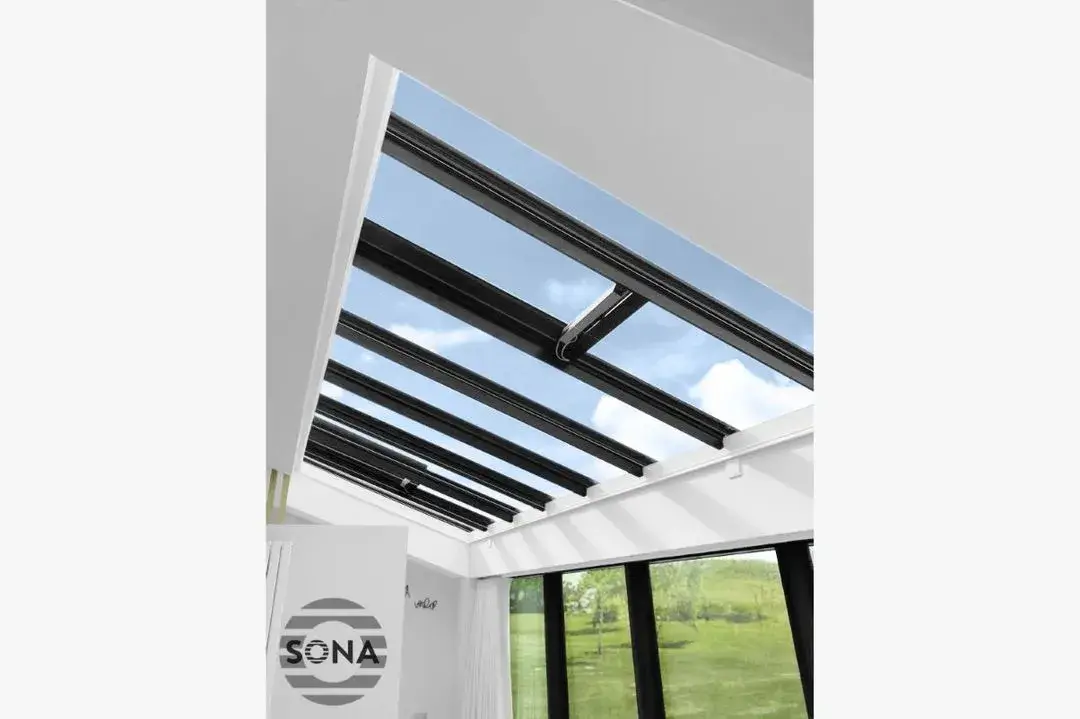 an open electric rooflight blind covering a slanted roof window.