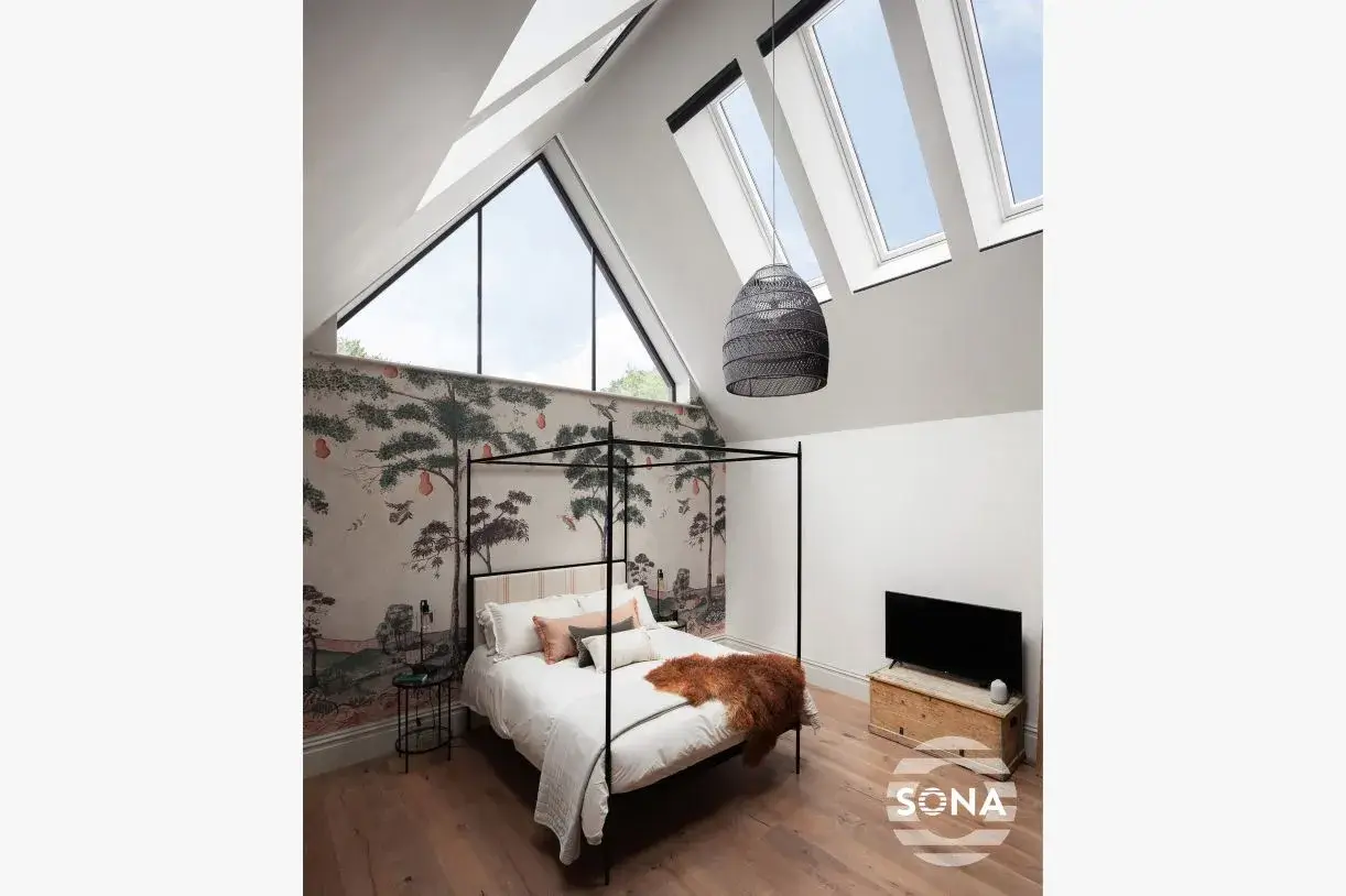 showing open rooflight blinds in a loft bedroom